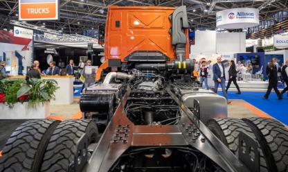 dynamic view of the back of an orange truck without a container at the SOLUTRANS trade fair