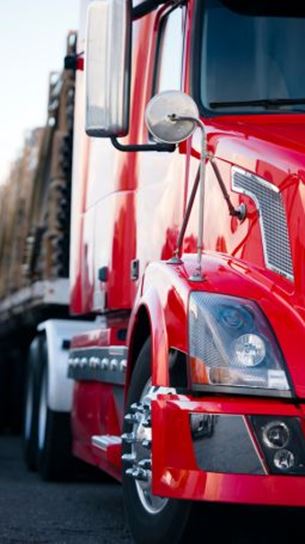 Red semi truck with modern trailer