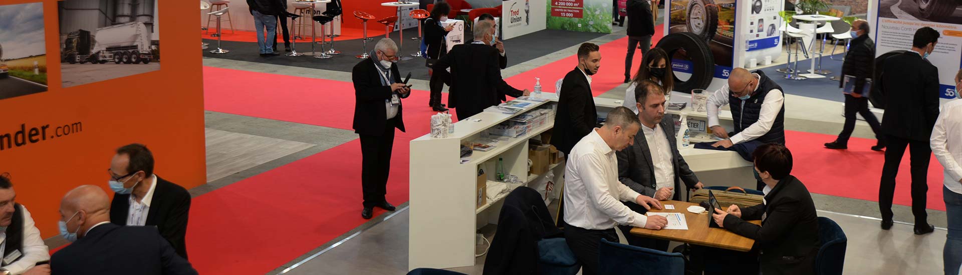 Exhibitors discussing around a stand