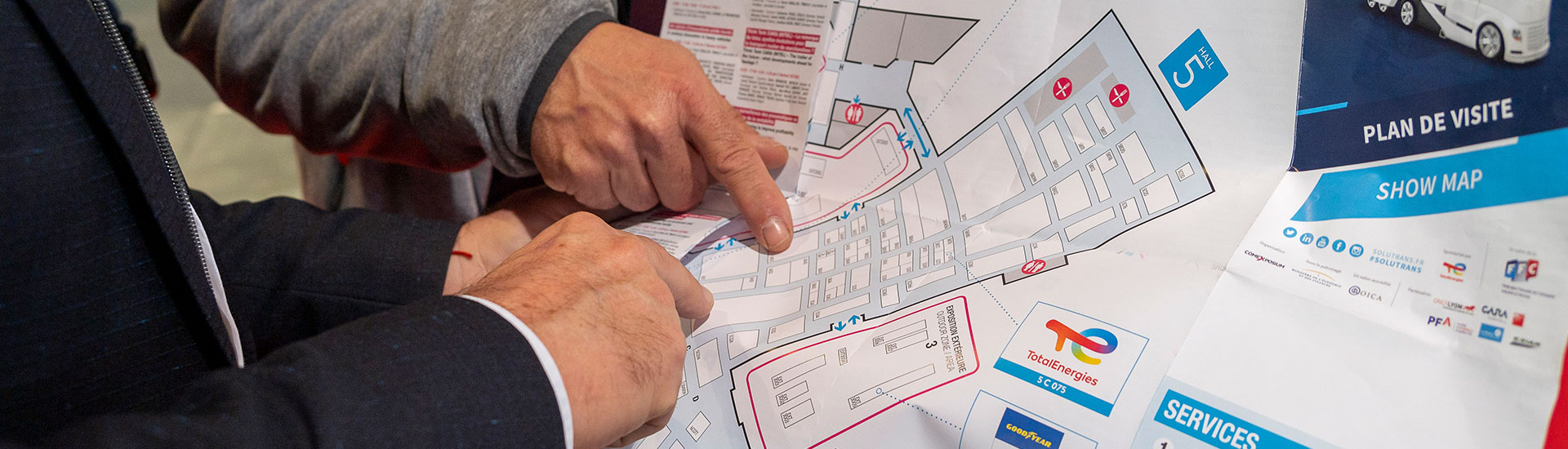 Visitors holding the SOLUTRANS exhibition map