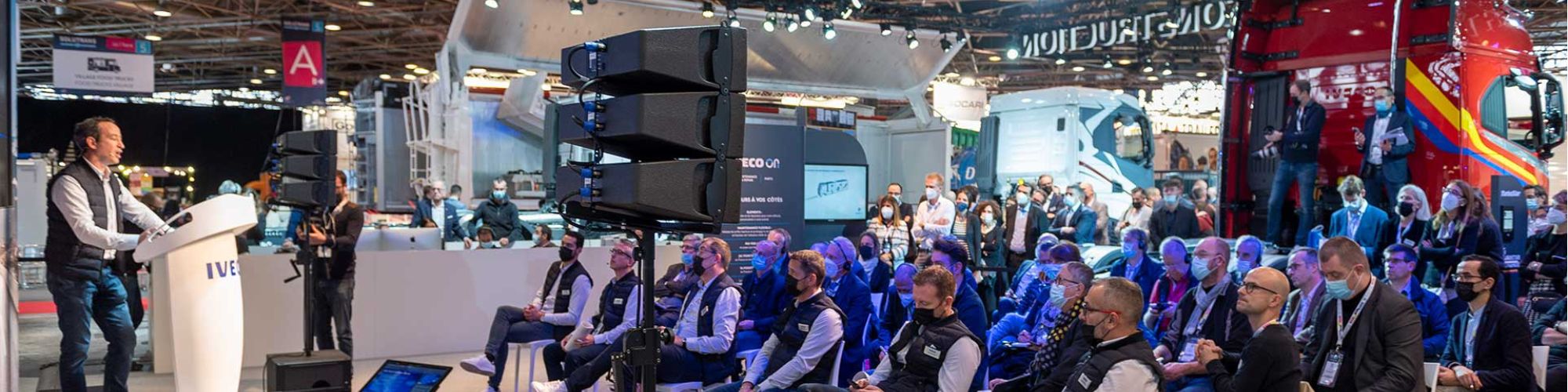 Bannière SOLUTRANS 2023 avec des groupes de professionels écoutant une prise de parole