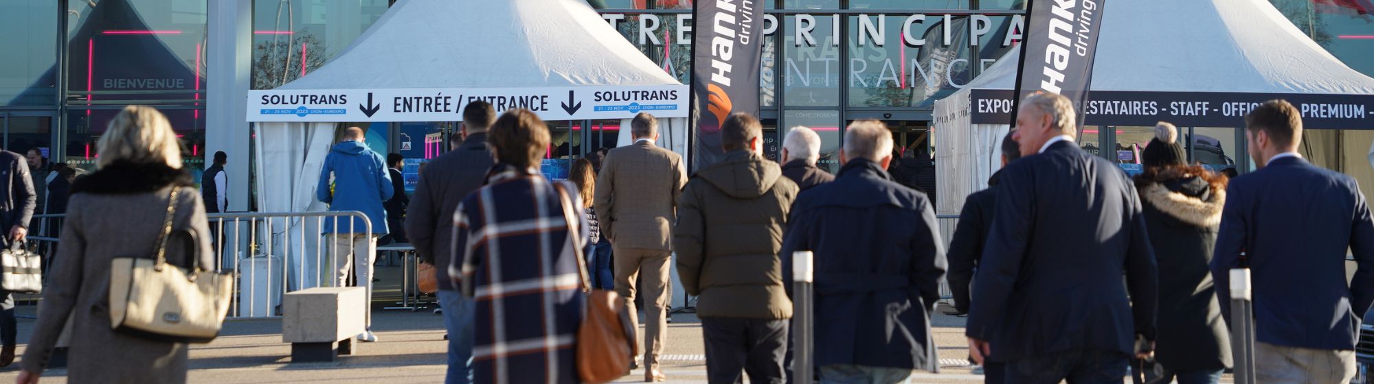 Trade exhibition entrance with group of people for SOLUTRANS 2023