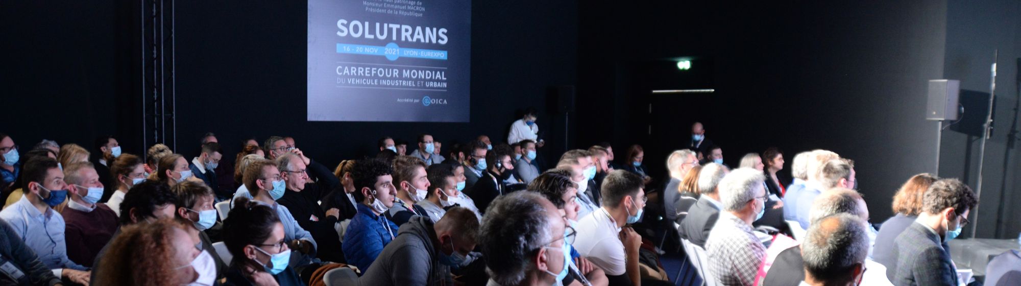 Large group of people seated and attending a conference
